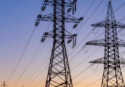 Transmission towers with orange blue sunset